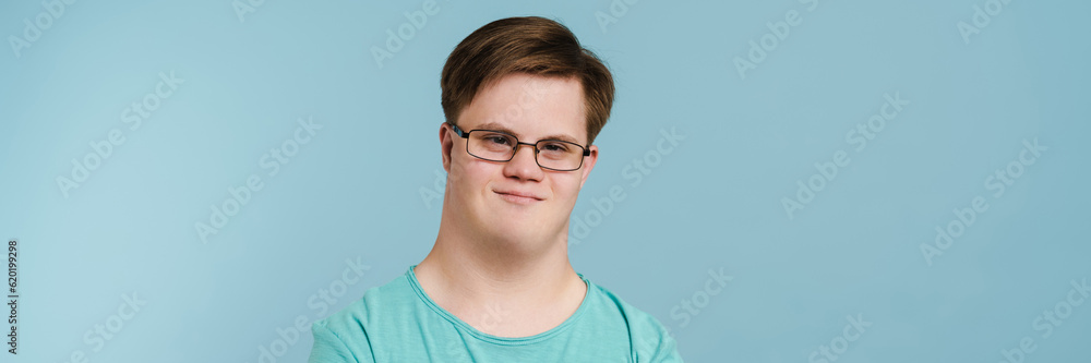 Young man with down syndrome smiling and looking at camera