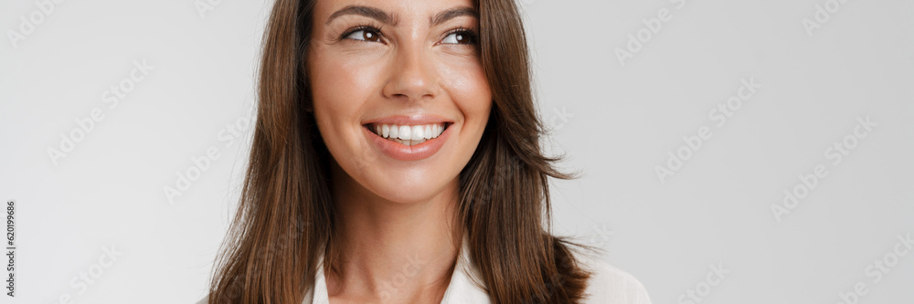 Young european woman in shirt smiling and looking aside Young european woman in shirt smiling and looking aside