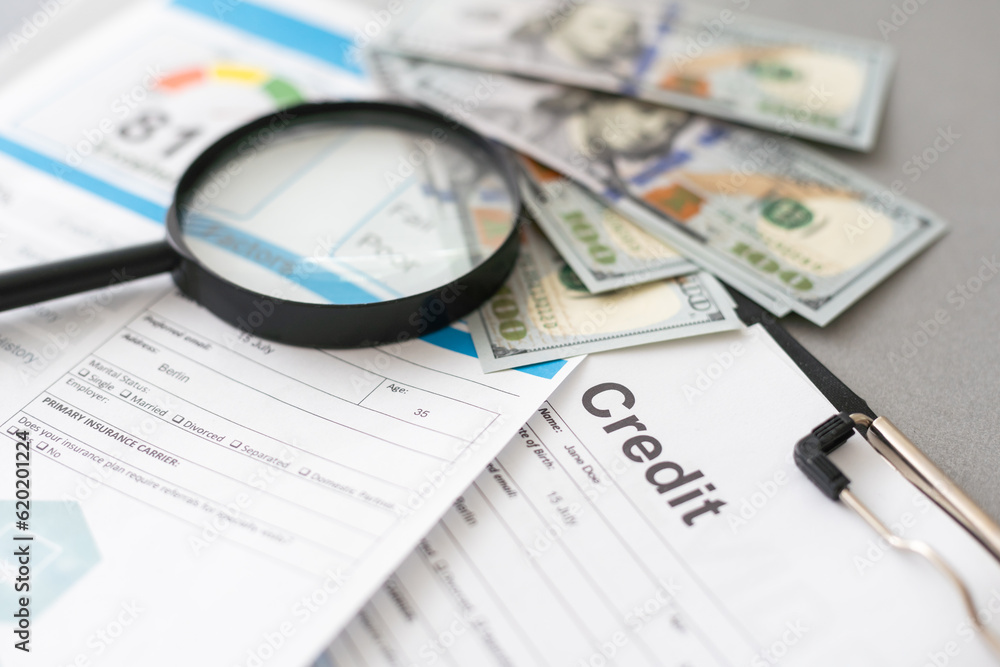 Magnifying glass, pen and calculator on financial chart and graph, accounting background Magnifying glass, pen and calculator on financial chart and graph, accounting background