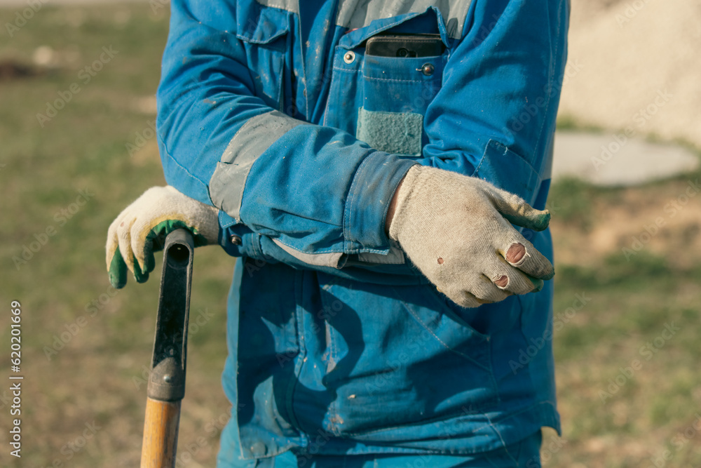 Close-up of a man's hands wearing construction gloves