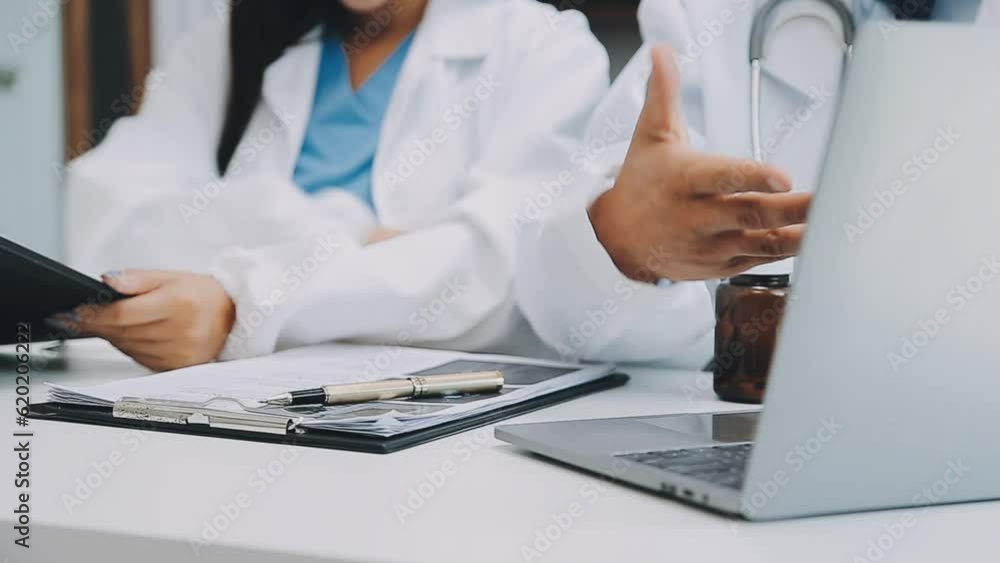 Team of doctors and businesswoman having a meeting in medical office Team of doctors and businesswoman having a meeting in medical office