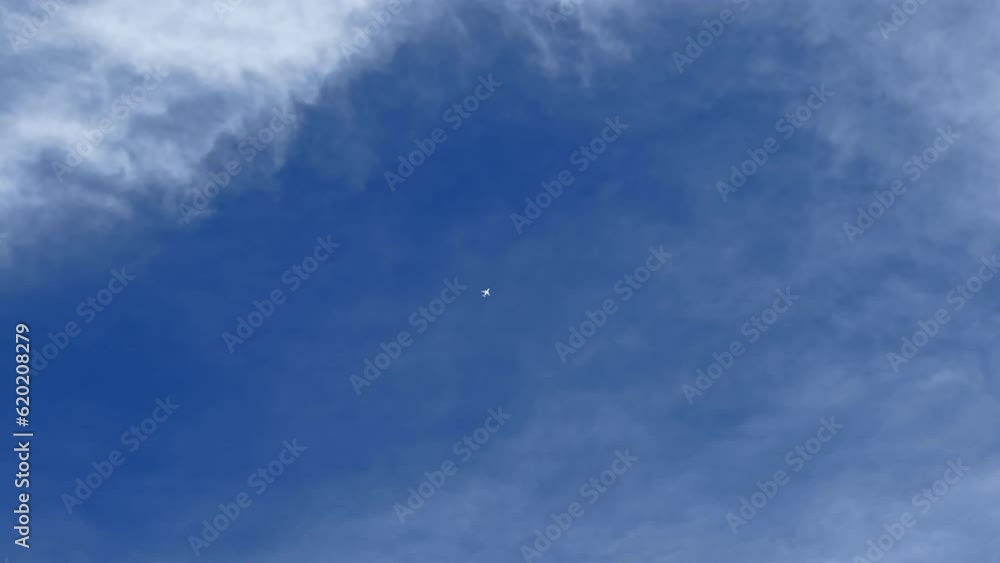A jet airplane crossing the blue sky. Cloudscape, Japan. A jet airplane crossing the blue sky. Cloudscape, Japan.