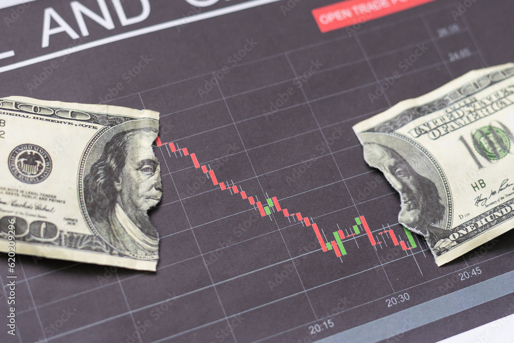 Fotografie US dollar banknotes stacks over digital screen with exchange chart, depreciation