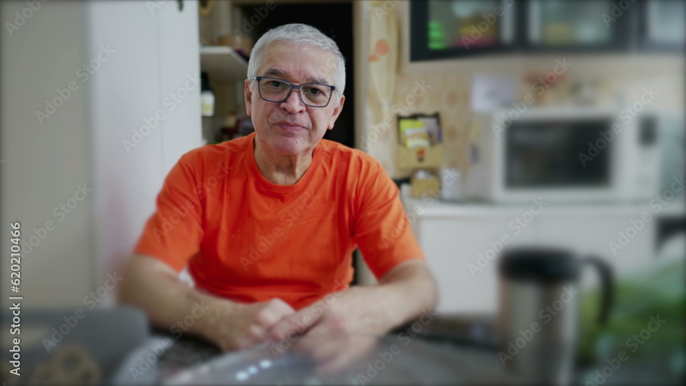 Portrait of a senior man in kitchen setting, elderly person looking at camera in domestic scene Portrait of a senior man in kitchen setting, elderly person looking at camera in domestic scene