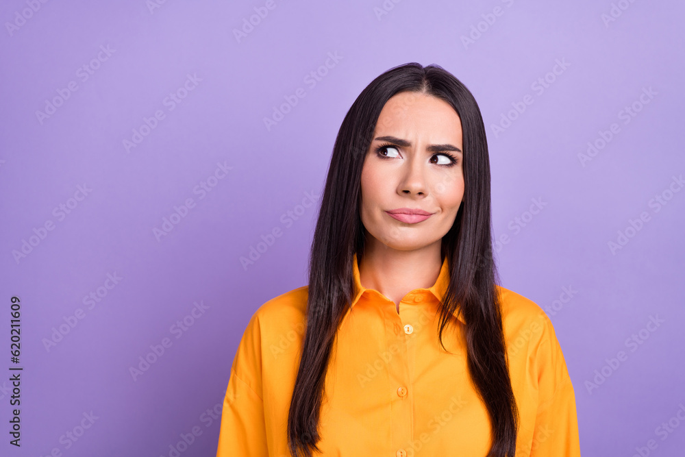 Photo of young woman suspicious watching empty space information message about inflation economics news isolated on purple color background Photo of young woman suspicious watching empty space information message about inflation economics news isolated on purple color background
