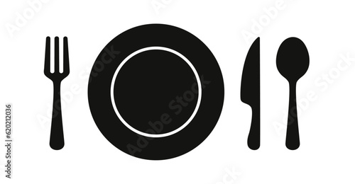 Spoon, fork, knife and plate on the dining table