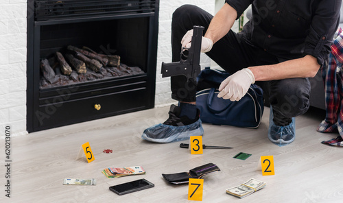 Detective Collecting Evidence in a Crime Scene. Forensic Specialists Making Expertise at Home of a Dead Person. Homicide Investigation by Professional Police Officer. © Angelov