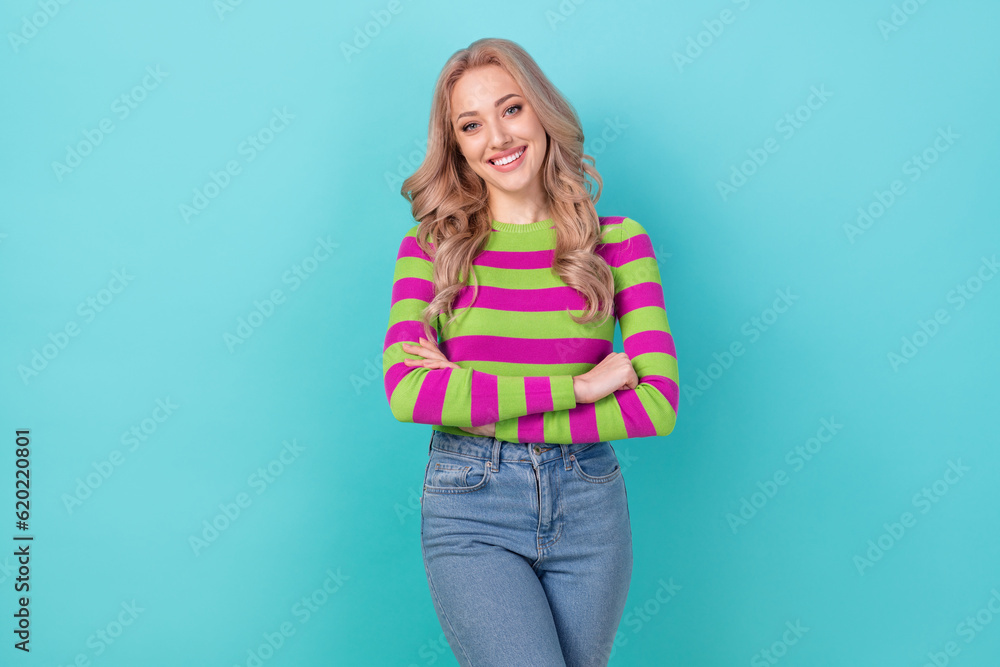 Photo portrait of attractive young woman smile crossed arms shop promotion wear trendy striped clothes isolated on cyan color background Photo portrait of attractive young woman smile crossed arms shop promotion wear trendy striped clothes isolated on cyan color background