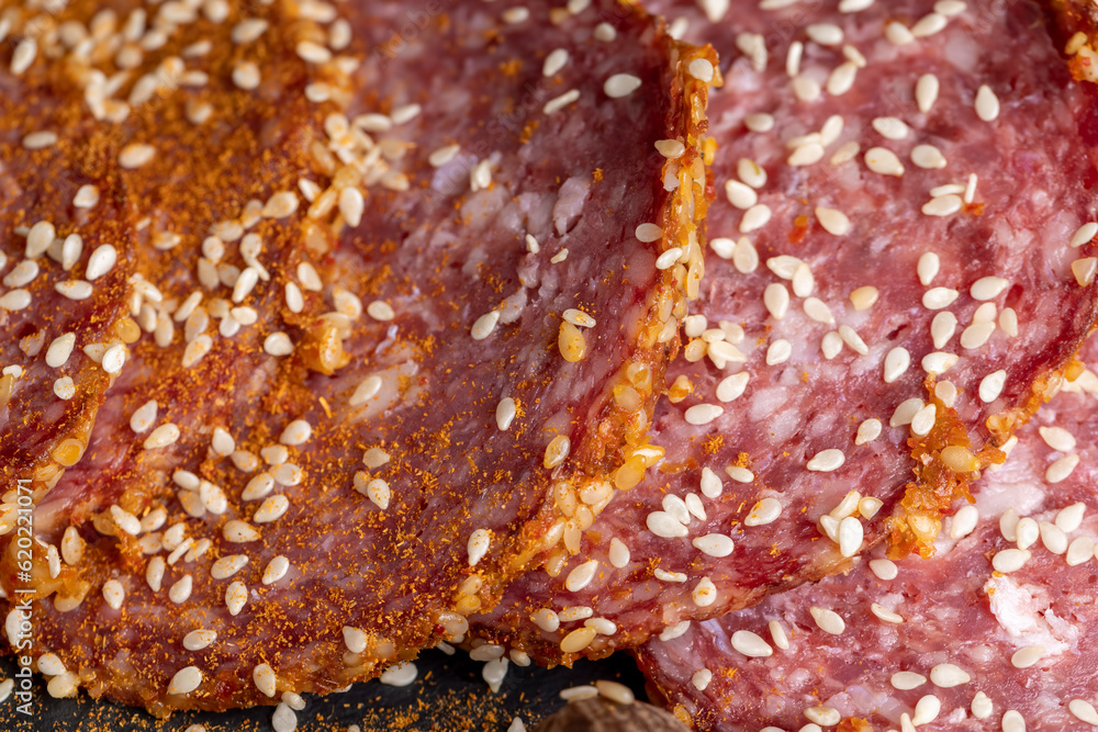 Sliced pork and beef sausage with spices and lots of sesame seeds Sliced pork and beef sausage with spices and lots of sesame seeds