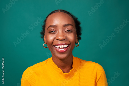 Fotografie, Obraz Beautiful Black woman laughs, studio teal background, fashion lifestyle portrait