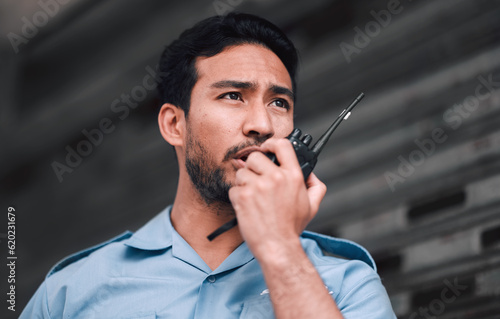 Walkie talkie, security guard or safety officer man outdoor for protection, patrol or watch. Law enforcement, transceiver and duty with a crime prevention male worker in uniform with communication