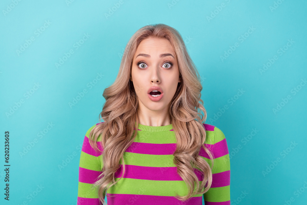 Photo portrait of lovely young lady afraid open mouth speechless wear trendy striped garment isolated on cyan color background Photo portrait of lovely young lady afraid open mouth speechless wear trendy striped garment isolated on cyan color background