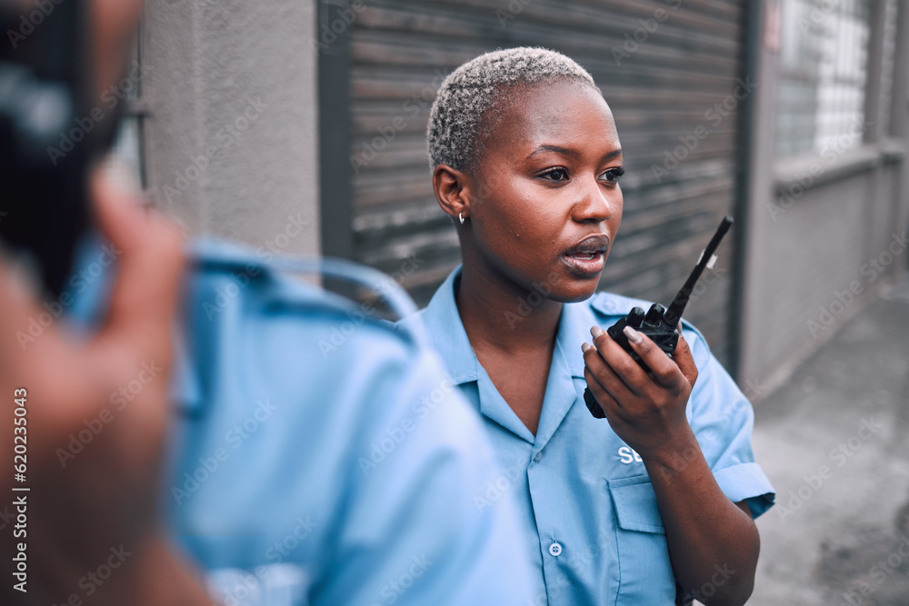 Security, walkie talkie and a police woman in the city during her patrol for safety or law enforcement. Radio, communication and service with an african female guard on a street in an urban town - obrazy, fototapety, plakaty 