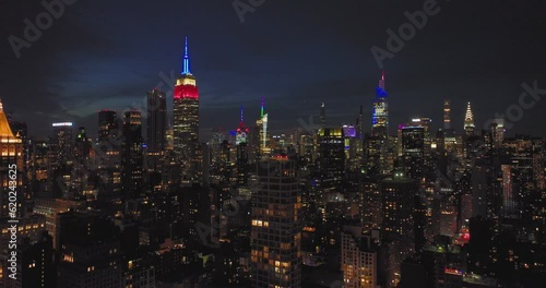 Dark Night NYC skyline aerial of Manhattan buildings and lights red white and blue
