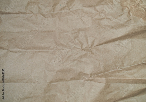 Brown wrapping paper texture, crumpled clean sheet. Craft crumpled paper, cardboard background.