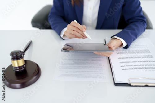 Lawyer working legal data contract at workplace..