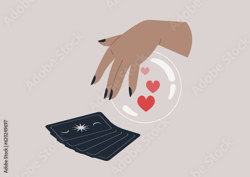 Fortune teller reading the deck of tarot cards, a love potion brewing inside a crystal ball