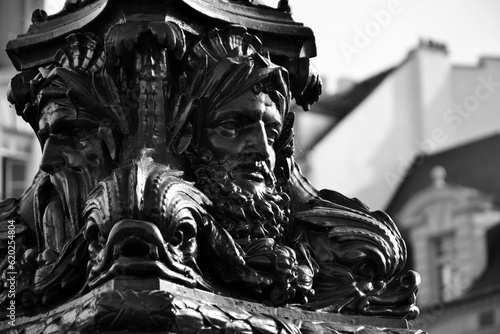 Paris, France - march 10th 2017 : detail of a standard lamp used for the public lighting, in form of old men or antic divinities.