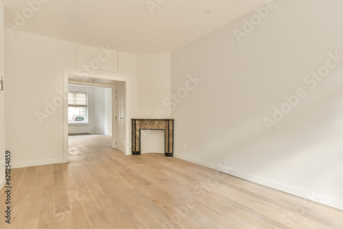an empty living room with wood floors and white walls, including a fireplace in the floor is made of hardwood