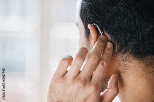 Hearing aid, face and ear of man with disability from the back on mockup space. Closeup of deaf person, medical device or implant of sound waves, audiology or help of listening equipment for wellness