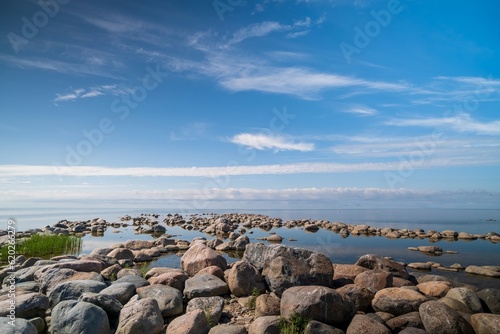 Fototapeta Naklejka Na Ścianę i Meble -  The rocky shore of the Baltic Sea. Beautiful sunny summer day, calm sea. Baltic Sea Estonia Kihnu Island