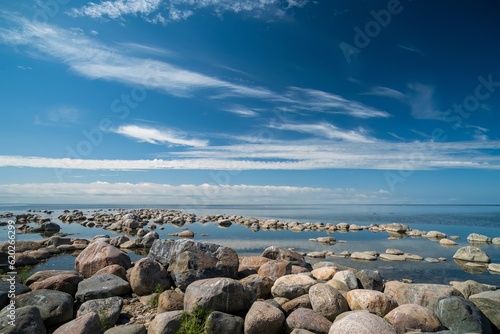 Fototapeta Naklejka Na Ścianę i Meble -  The rocky shore of the Baltic Sea. Beautiful sunny summer day, calm sea. Baltic Sea Estonia Kihnu Island