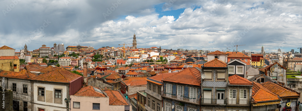Panorama Porto town, Portugal. Wide angle view from the top, red roofs, church tower in background. Darker and moody sky.