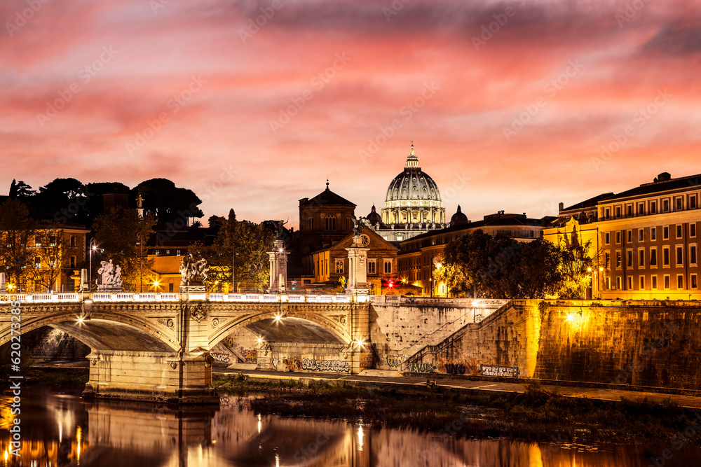 Scenic view of the Vittorio Emanuele II Bridge across the Tiber and the dome of St. Peter's Cathedral in the Vatican at sunset. Rome, Italy