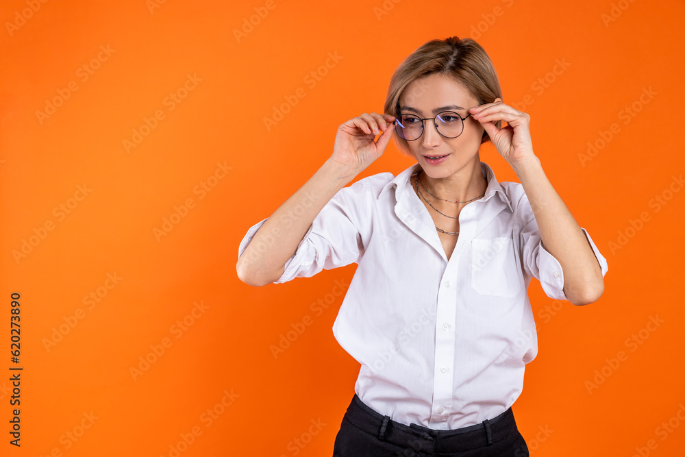 Attractive woman wearing white official style shirt holding frame of glasses looking away Attractive woman wearing white official style shirt holding frame of glasses looking away