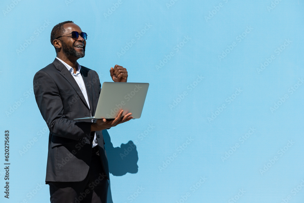 Mature businessman in elegant suit with a laptop looking busy