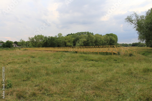 A yellow bridge in a field