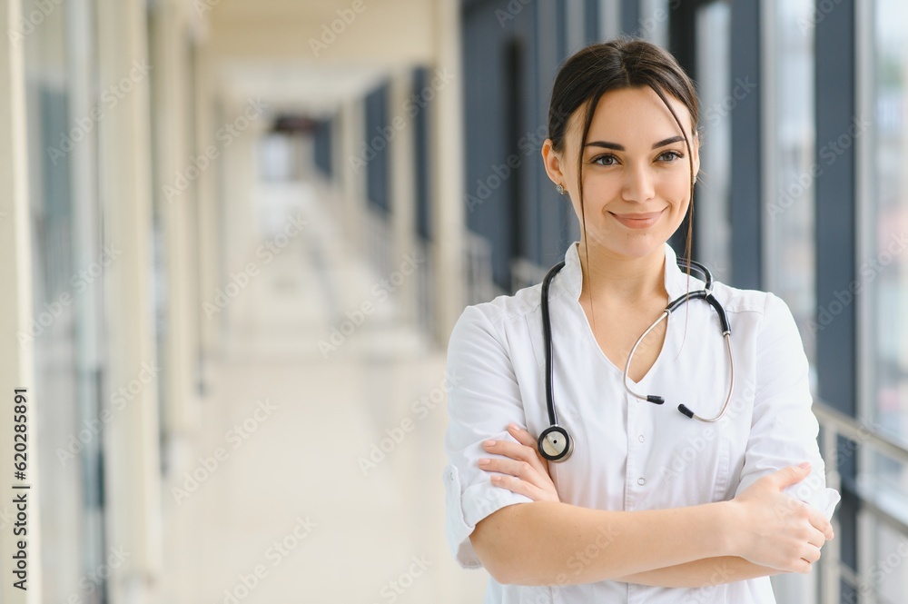 Portrait of young woman doctor with white coat standing in hospital. Portrait of young woman doctor with white coat standing in hospital.