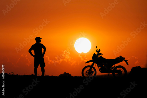 Man with motocross bike against beautiful lights