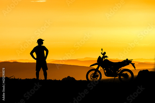 Man with motocross bike against beautiful lights