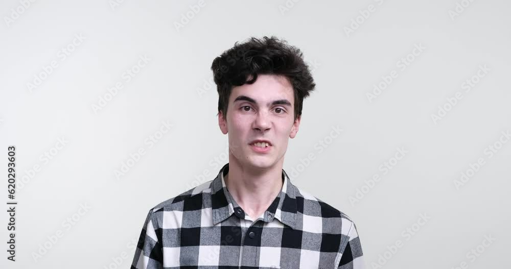 Against a stark white background, a curly-haired man of Caucasian descent stands with an air of aggression and fury. His piercing gaze reveal a seething anger that simmers just beneath the surface. Against a stark white background, a curly-haired man of Caucasian descent stands with an air of aggression and fury. His piercing gaze reveal a seething anger that simmers just beneath the surface.