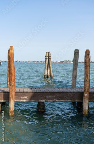 A wooden mooring pier and mooring piles on the Grand Canal in Venice  Italy.