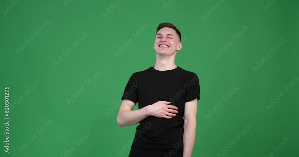 A satisfied Caucasian man is seen on a green background, laughing joyfully. His face is lit up with a wide smile, and his eyes sparkle with happiness. A satisfied Caucasian man is seen on a green background, laughing joyfully. His face is lit up with a wide smile, and his eyes sparkle with happiness.