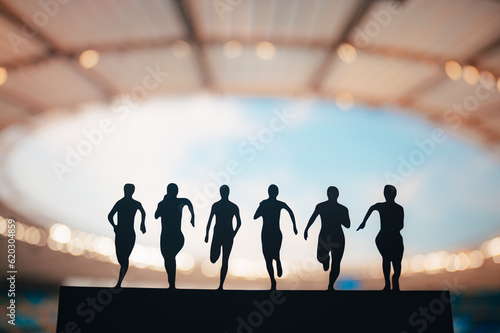 Unified in Motion: Silhouette of Sprinters Showcasing Strength and Determination at Modern Stadium. Track and Field Summer Games 2024 in Paris.