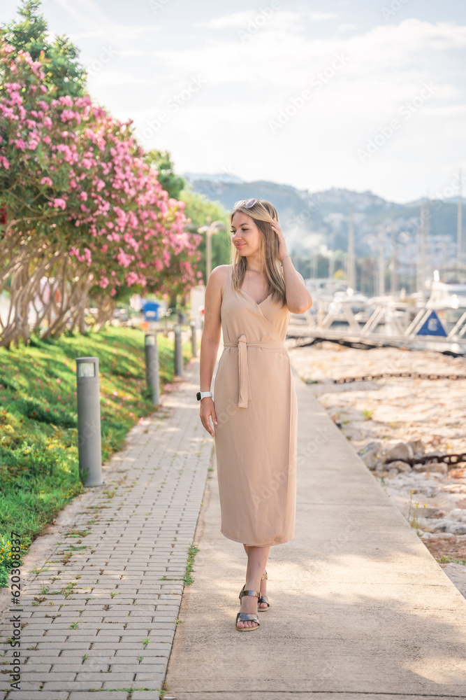 A beautiful fashion caucasian woman on luxury yachts background in marina