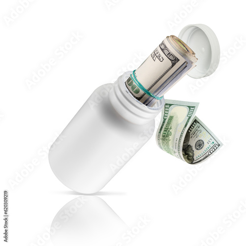 Pieniądze ukryte w białej butelce na lekarstwa.  Z butelki wylatuje rulon pieniędzy.  Setki , tysiące dolarów w opakowaniu medycznym. Może oznaczać łapówki lub drogie leczenie. photo