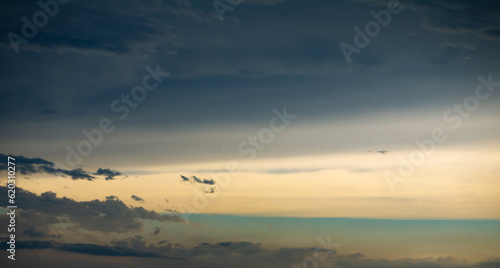 Tableau sur toile Yellow and green sky with parting clouds after rain at sunrise or sunset shot at