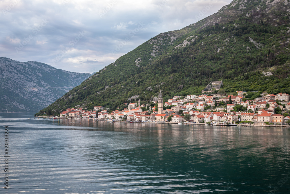 Landscape Exposure done from a cruise ship at sunset, showing the sea entrance to Kotor bay and its beautiful coastal landscapes and small villages , on a sunshiny day.