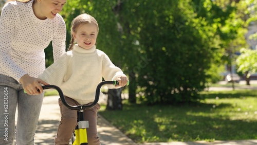 child learn ride bike. mother daughter girl park. happiness smile little child mom. dream family., mother teaches little smiling child ride bike, motherhood childhood, cardio, go faster, concept