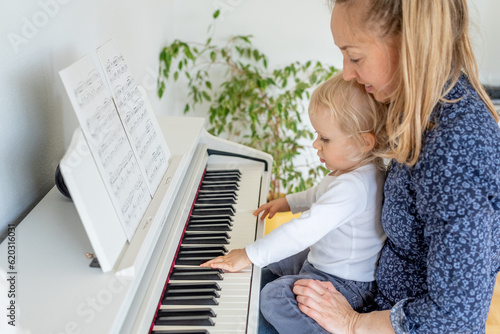 Mother and child playing piano