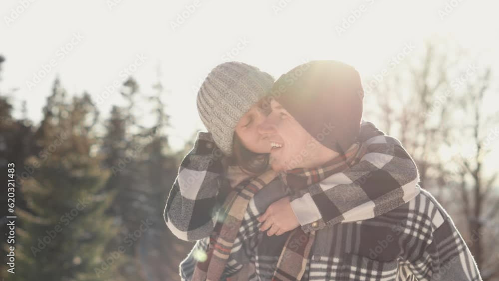 The video embodies the energy, joy and passion of a couple who overwhelm a winter walk in nature. The girl hugs her boyfriend and they have fun. Vacations and outdoor recreation The video embodies the energy, joy and passion of a couple who overwhelm a winter walk in nature. The girl hugs her boyfriend and they have fun. Vacations and outdoor recreation