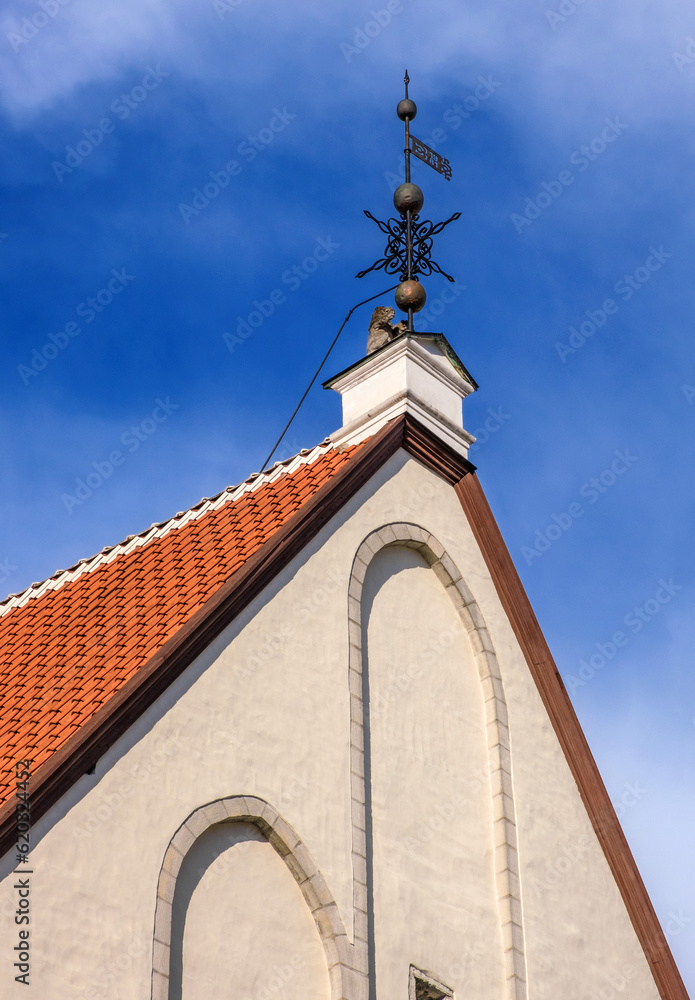 Tallinn, Estonia - architectural details of old town houses - weather vane on the roof of an old house