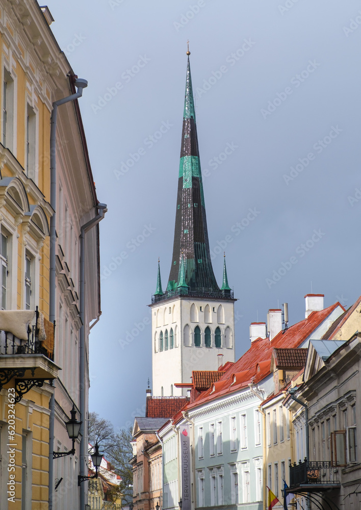 The bell tower of the Church of St. Olaf. Tall beautiful spire of the church. Tallinn, Estonia