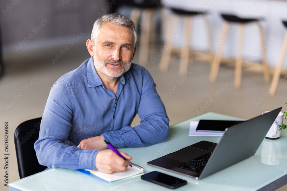 Mature businessman working on laptop computer Mature businessman working on laptop computer