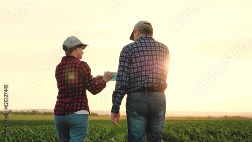 two farmers work tablet sun, farming, teamwork group people, contract handshake agreement, walking sunset examining team work day farmland tablet computer golden shining farmers approaching business © Валерий Зотьев