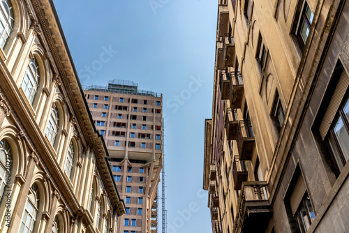 A street of Milan city center with Torre Velasca in the background, in Milan, Lombardy region, Italy photo